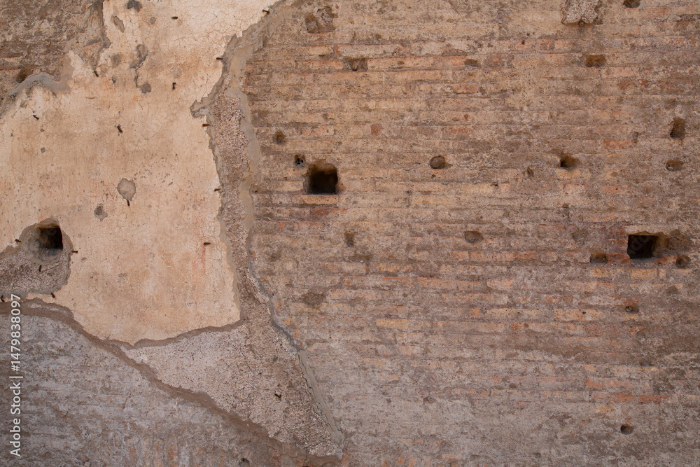Poster high-resolution image of an old roman wall texture with holes and damaged plaster. perfect for backg