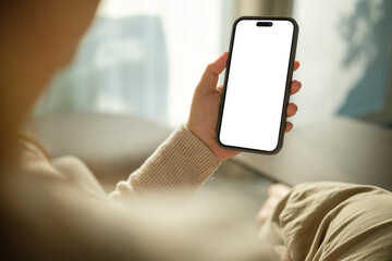 Close up of woman holding smartphone with blank screen, for mobile app mockups or digital content