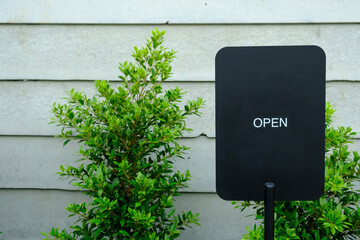 Exterior View of Open Business Sign on Textured Wall