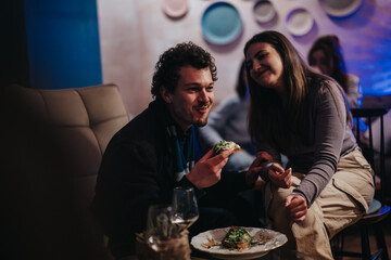 A group of friends enjoying food and conversation in a stylish and cozy lounge environment. The image captures the warmth, comfort, and social connection present during such gatherings.