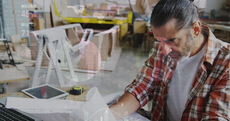Image of world map and data processing over caucasian male carpenter working in workshop
