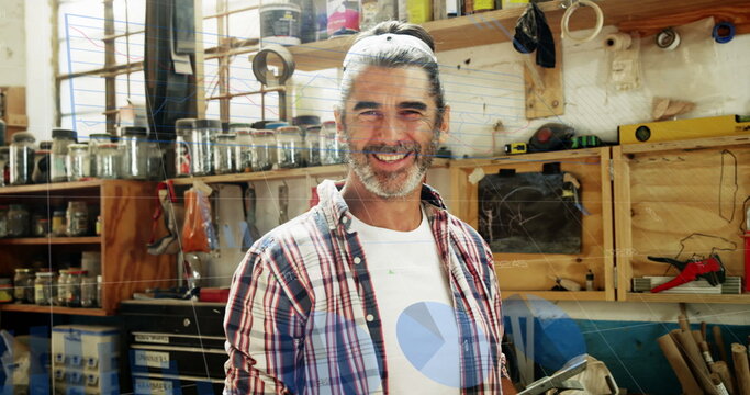 Image of data processing over happy caucasian male carpenter working in workshop