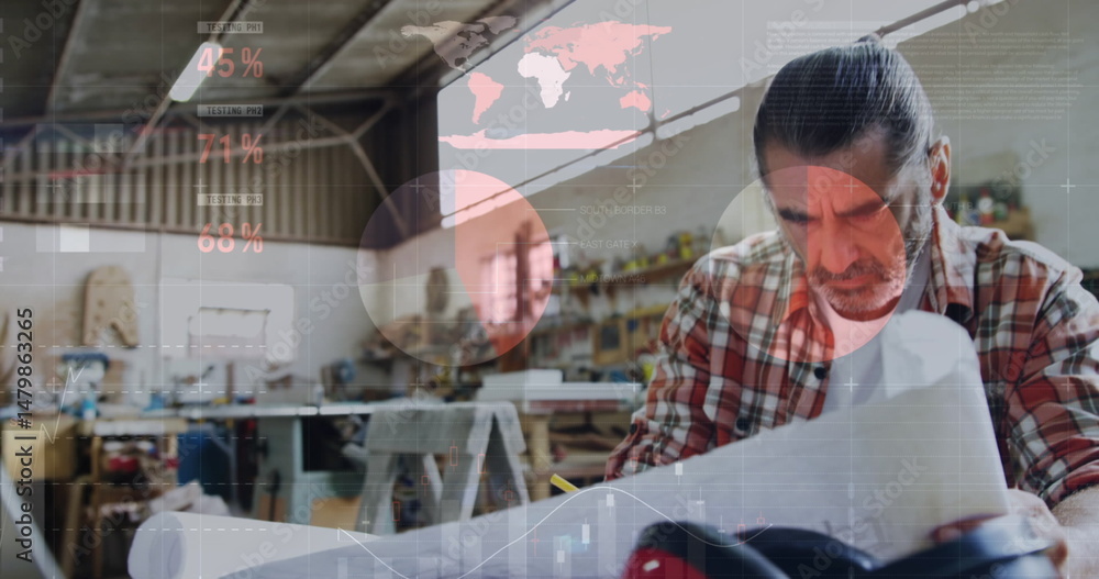 Poster image of world map and data processing over caucasian male carpenter studying plans in workshop