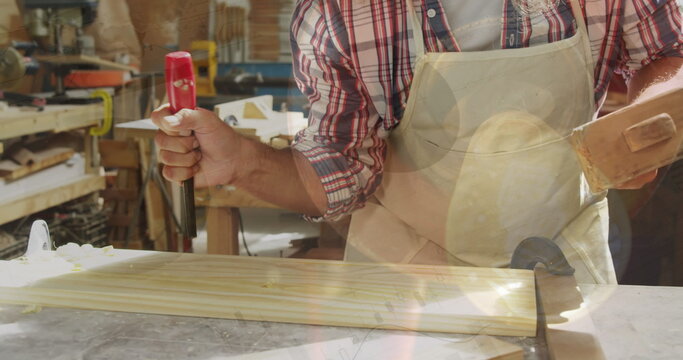 Image of data processing over caucasian male carpenter working in workshop