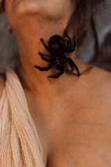 Girl in an abandoned place in a web with a spider