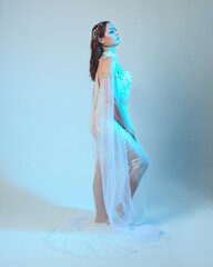 Fantasy studio portrait of a red-haired mermaid faery wearing a white pearl gown, fairytale...
