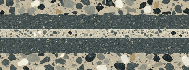 Textured concrete floor with dark gray and light beige/cream colored chips and a light gray/white horizontal stripe