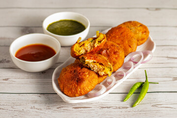 Onion kachori is a crispy, deep-fried Indian snack filled with spiced onion mixture, popular in Rajasthan, especially during tea time.
