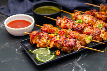 Chicken satay is grilled, marinated chicken skewers served with a rich, savory peanut sauce,...