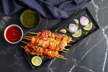 Chicken satay is grilled, marinated chicken skewers served with a rich, savory peanut sauce,...