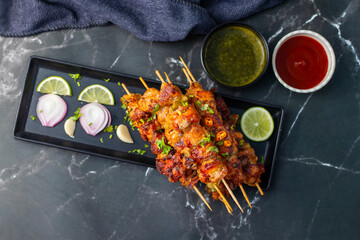 Chicken satay is grilled, marinated chicken skewers served with a rich, savory peanut sauce, popular in Southeast Asian cuisine.
