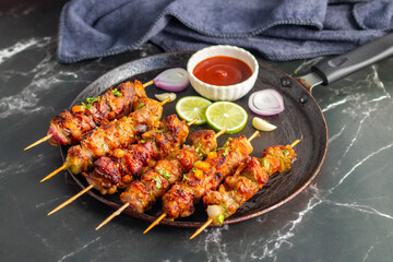 Chicken satay is grilled, marinated chicken skewers served with a rich, savory peanut sauce, popular in Southeast Asian cuisine.
