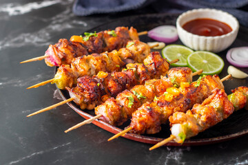 Chicken satay is grilled, marinated chicken skewers served with a rich, savory peanut sauce, popular in Southeast Asian cuisine.
