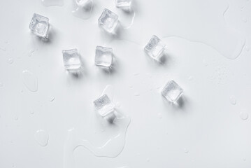 Melting ice cubes in a splash of water on a white background