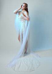 Fantasy studio portrait of a red-haired mermaid faery wearing a white pearl gown, fairytale...