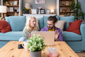 Young intelligent innovative hipster couple presenting their startup new business idea via video...