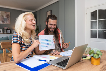 Young intelligent innovative hipster couple presenting their startup new business idea via video...