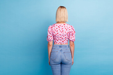 Rear side photo of adorable gorgeous lovely girl wear stylish clothes collection empty space...