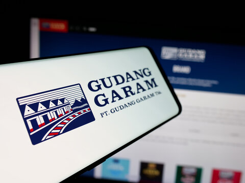 Stuttgart, Germany - 05-02-2025: Smartphone with logo of Indonesian tobacco company Gudang Garam on screen in front of website. Focus on center-left of phone display.