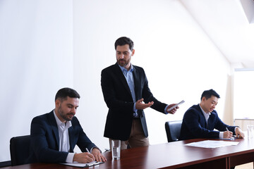 Business conference. People in meeting room listening to speaker report