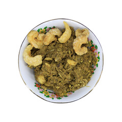 Top view of Nam Prik Noom, a Northern Thai green chili dip made from roasted chilies and garlic, served with crispy pork rinds in a traditional floral bowl.