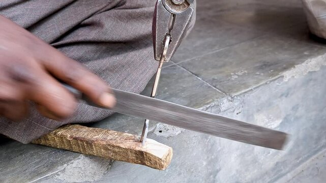 Top close-up shot of an Indian locksmith manually making a duplicate house key.manual key making