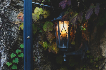 Old-fashioned streetlight on a brick wall.