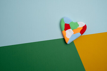 Autism awareness day, world autism day. Colored heart on color background