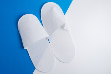 Disposable slippers on a colored background
