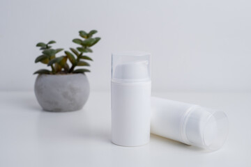 Container for cream, shampoo, toiletries, spa. Unbranded white plastic bottles. Bottle with a dispenser for cosmetic products. Skin care and beauty concept. Mockup style, copy space  
