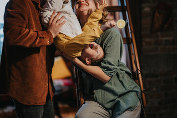 Parents and children share fun-filled moments inside their cozy home, illustrating joy, bonding, and the essence of family moments.