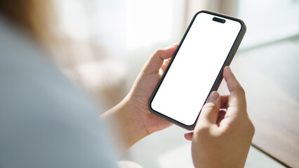 Hands using mobile phone with empty display ready for design, app interface showcase or digital product preview.