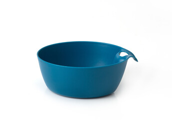 Blue plastic bowl with a handle on white background, simple studio shot for kitchenware or cooking-related content.