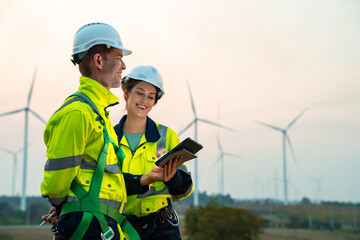 Technician and Engineer Working on a Windmill Turbine in the Field, Harnessing Renewable Energy for...