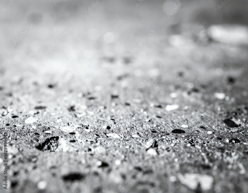 Aufkleber a close-up view of a textured surface featuring various small stones and particles in black and whit