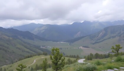 Fototapeta premium Expansive mountain valley landscape with winding road and overcast sky