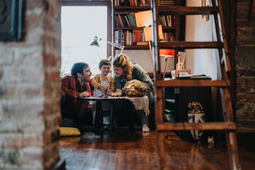 A family spends meaningful moments in their warm living room, surrounded by books and home coziness, creating lasting bonds and memories.