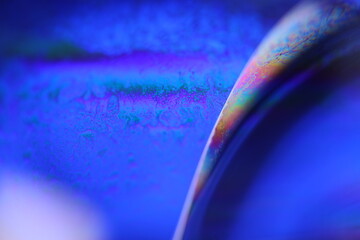 Deep blue liquid surface on black background, oil stains movement, bright chemistry, surreal...