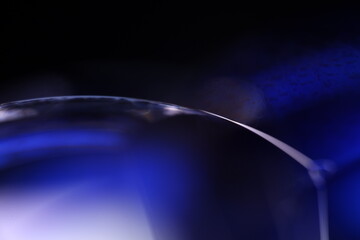 Deep blue liquid surface on black background, oil stains movement, bright chemistry, surreal...