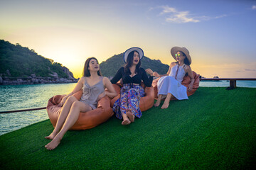 Group of friend in boat sailing arounfd at coast of Koh Tao, Koh nangyuan sightseeing sunset together summer traveling