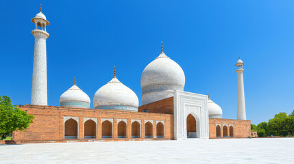 Fototapeta premium Stunning architectural marvel featuring grand mosque with multiple domes and minarets, set against clear blue sky