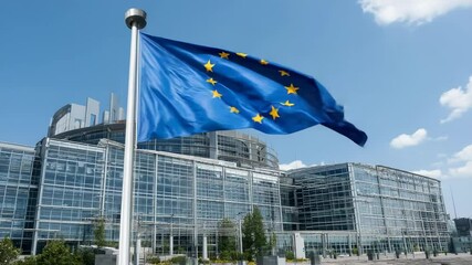 European Union flag waving in front of modern glass parliament building with clear sky and sunny weather - Powered by Adobe