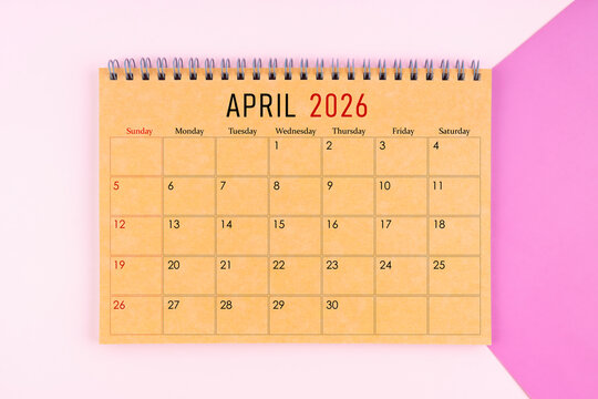 April 2026 desk calendar made from brown paper page on purple background.