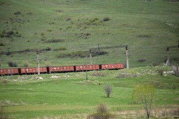 Train in the mountains. Railway in the mountains. Train on the railway tracks
