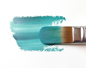 Teal paint stroke with a paintbrush.  The brush is positioned with the bristles in contact with a teal paint stroke on a white background