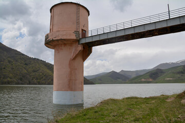 Reservoir and dam. Lighthouse in the reservoir. Lake in the mountains. Waterfall in the reservoir...