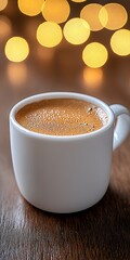 Warm Coffee in White Mug with Blurry Golden Background Bokeh
