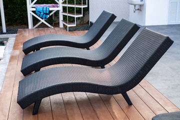 Modern outdoor rattan lounge chair with ergonomic design, perfect for poolside relaxation or garden decor. Stylish, durable, and weather resistant