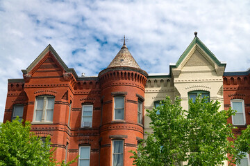 A row of townhouses on Capitol Hill in Washington, D.C. The tops of the houses are against the sky.