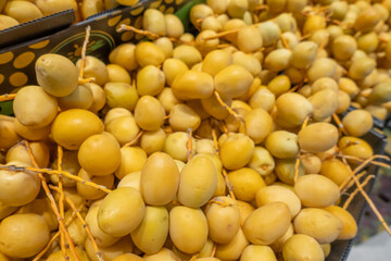 yellow dates on display in supermarket